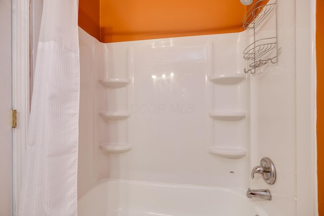 bathroom with shower / bath combination with curtain