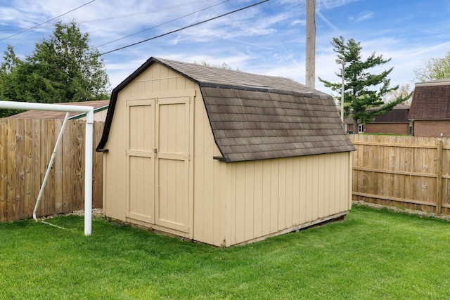 view of shed with a fenced backyard