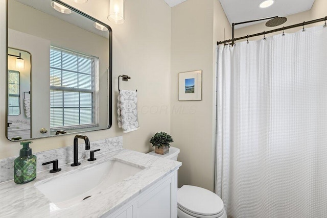 bathroom featuring vanity, toilet, and a shower with shower curtain