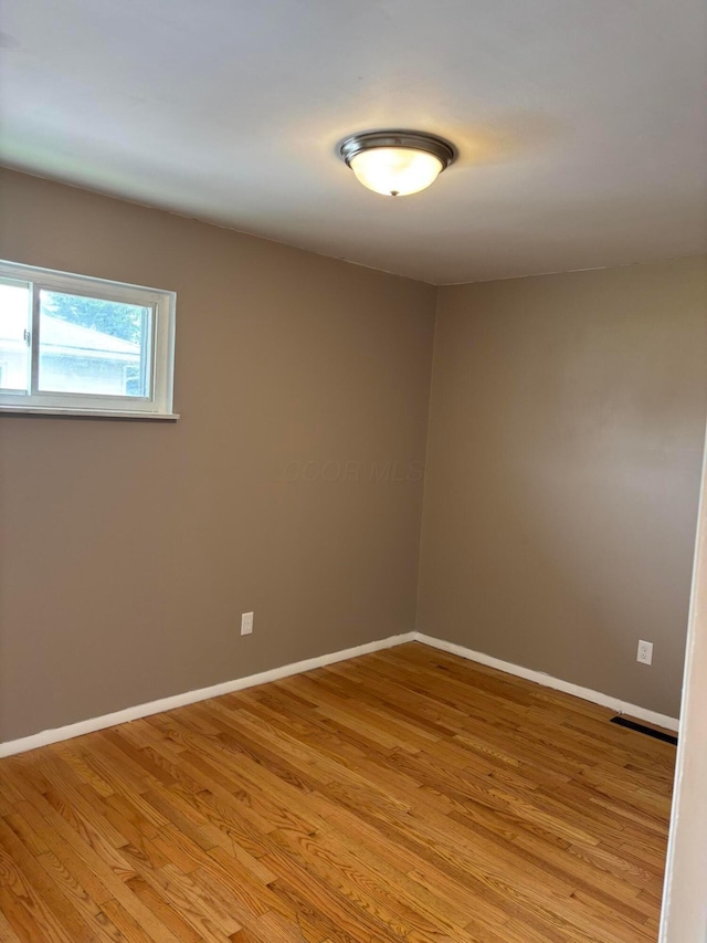 unfurnished room featuring light wood-style floors and baseboards