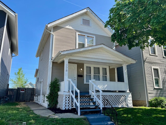 traditional style home with fence and a porch