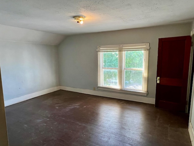 bonus room with baseboards, a textured ceiling, and lofted ceiling