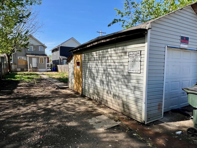view of side of property with fence and an outdoor structure