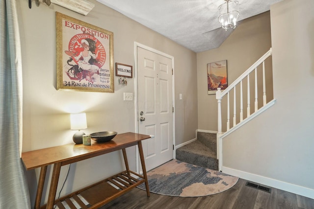 entrance foyer featuring baseboards, wood finished floors, and stairway