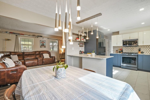 dining area featuring recessed lighting, a textured ceiling, and marble finish floor
