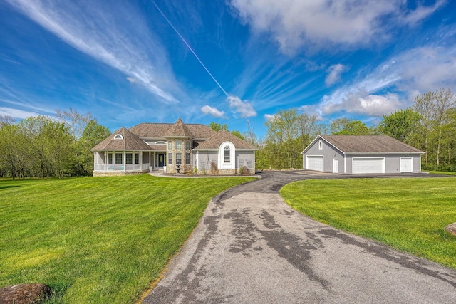 2051 River Rd, Delaware, OH 43015 - view of front of home featuring a front yard, a garage, an outbuilding, driveway, and stone siding