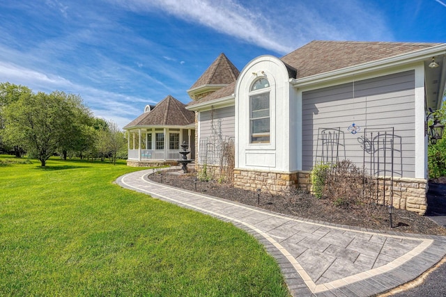 2051 River Rd, Delaware, OH 43015 - view of front of house featuring a front lawn, stone siding, and roof with shingles