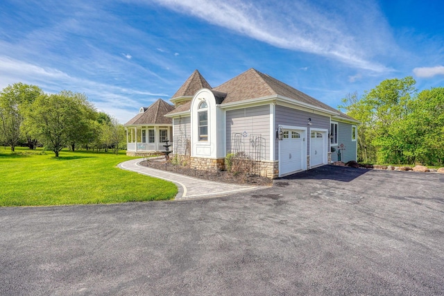2051 River Rd, Delaware, OH 43015 - view of front of property featuring an attached garage, a front lawn, stone siding, asphalt driveway, and a shingled roof