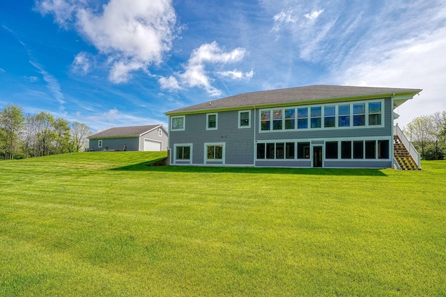 2051 River Rd, Delaware, OH 43015 - back of property with a lawn, a detached garage, and stairs