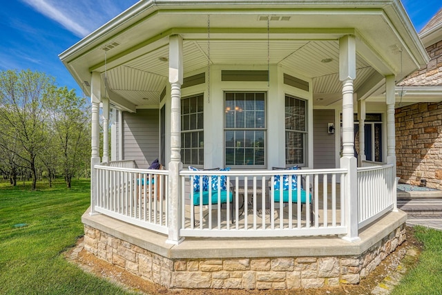 2051 River Rd, Delaware, OH 43015 - wooden deck featuring covered porch and a yard