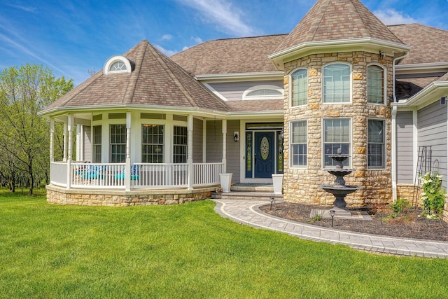 2051 River Rd, Delaware, OH 43015 - victorian house with covered porch, stone siding, a front lawn, and a shingled roof