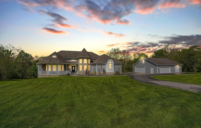 2051 River Rd, Delaware, OH 43015 - french country home with a detached garage, a yard, an outdoor structure, and a sunroom