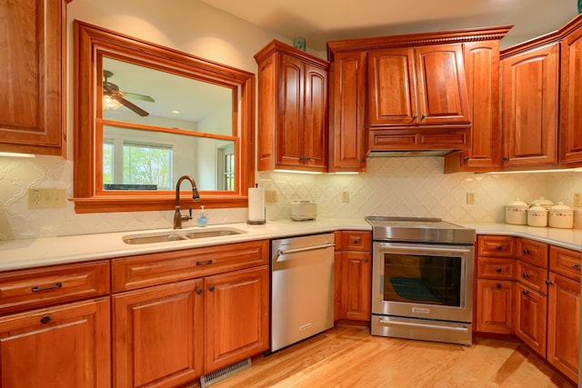2051 River Rd, Delaware, OH 43015 - kitchen featuring stainless steel appliances, a sink, light countertops, and light wood finished floors