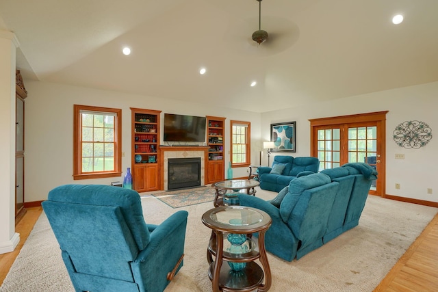 2051 River Rd, Delaware, OH 43015 - living area with lofted ceiling, light wood finished floors, baseboards, a glass covered fireplace, and plenty of natural light