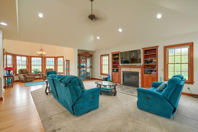 2051 River Rd, Delaware, OH 43015 - living area with a glass covered fireplace, high vaulted ceiling, a chandelier, baseboards, and recessed lighting