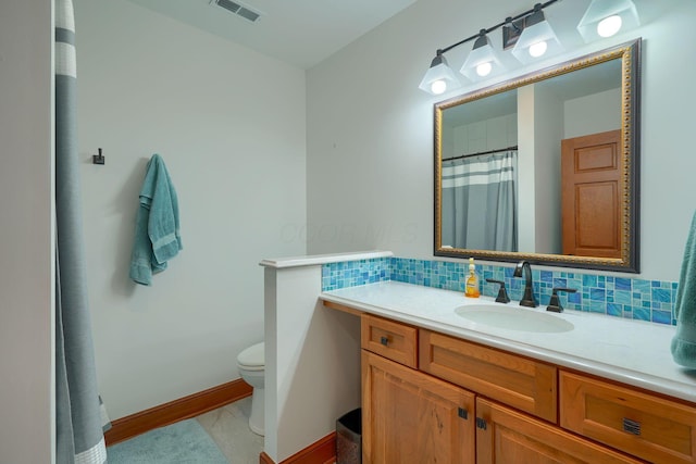 2051 River Rd, Delaware, OH 43015 - full bathroom with tasteful backsplash, toilet, vanity, and baseboards