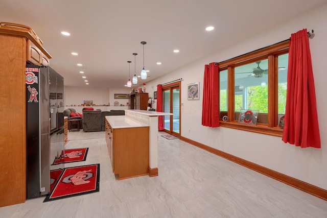 2051 River Rd, Delaware, OH 43015 - kitchen with freestanding refrigerator, open floor plan, light countertops, hanging light fixtures, and recessed lighting