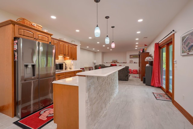 2051 River Rd, Delaware, OH 43015 - kitchen with stainless steel appliances, light countertops, open floor plan, a kitchen island, and recessed lighting