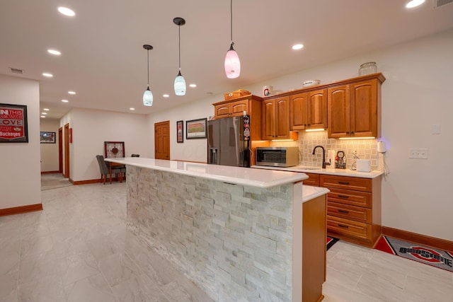 2051 River Rd, Delaware, OH 43015 - kitchen with stainless steel appliances, light countertops, a sink, a center island, and backsplash