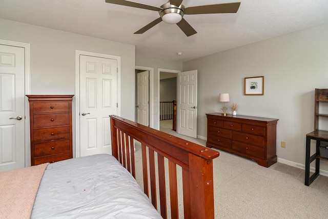 carpeted bedroom with baseboards and a ceiling fan