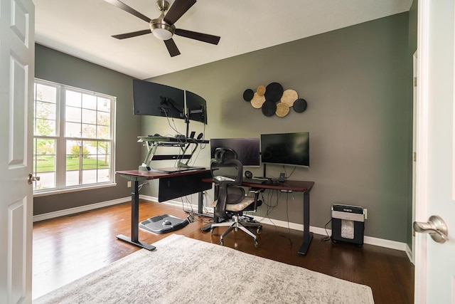 office area featuring baseboards, ceiling fan, and wood finished floors