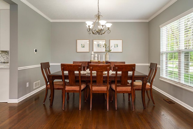 dining area featuring baseboards, visible vents, wood finished floors, and a chandelier