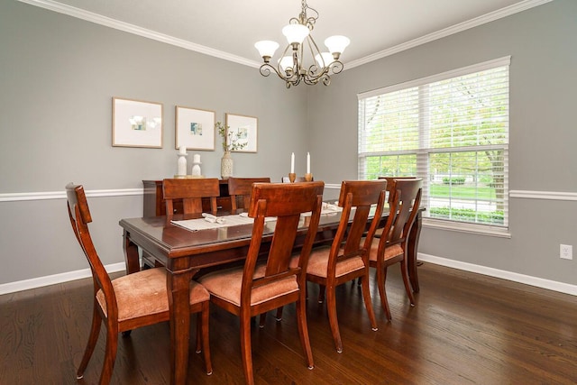 dining space featuring baseboards, ornamental molding, dark wood finished floors, and a notable chandelier