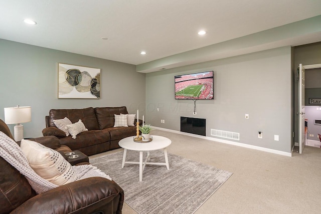 living area featuring recessed lighting, baseboards, visible vents, and light carpet