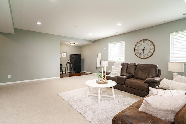 living room featuring baseboards, carpet, and recessed lighting