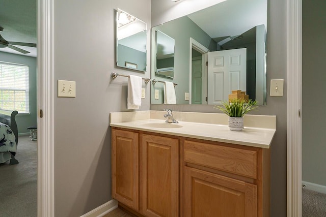 bathroom with ceiling fan, baseboards, and vanity