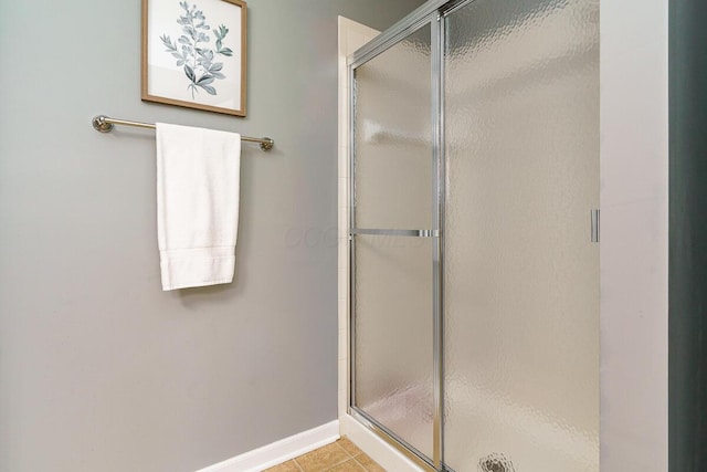 full bathroom with baseboards, tile patterned floors, and a stall shower