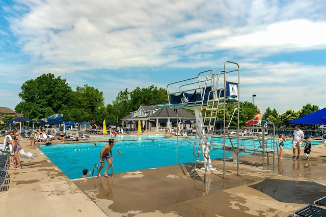 community pool featuring a water slide