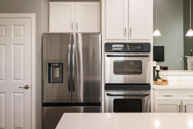 kitchen featuring white cabinetry, light stone countertops, and stainless steel appliances