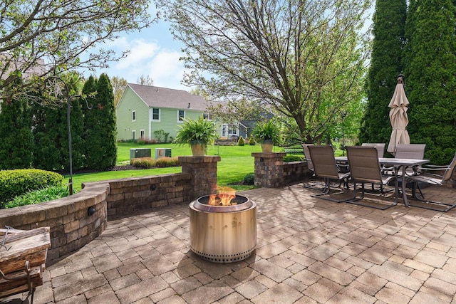 view of patio with outdoor dining space and an outdoor fire pit