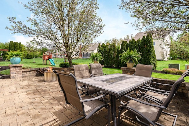 view of patio / terrace featuring outdoor dining area and a playground