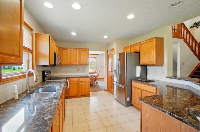1775 Harrison Pond Dr, New Albany, OH 43054 - kitchen with a sink, stainless steel fridge with ice dispenser, dark stone countertops, backsplash, and recessed lighting