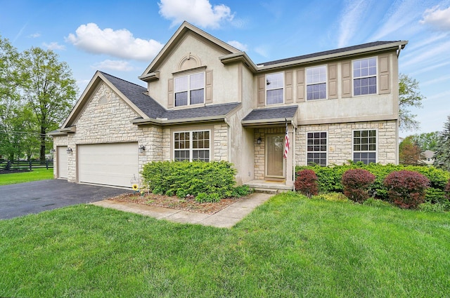 1775 Harrison Pond Dr, New Albany, OH 43054 - view of front of property with stone siding, asphalt driveway, stucco siding, and a front yard