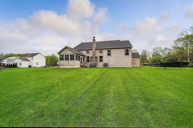 1775 Harrison Pond Dr, New Albany, OH 43054 - back of property featuring a yard, a chimney, central air condition unit, and a shingled roof