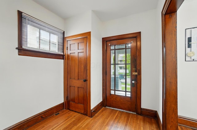 doorway to outside featuring light wood-style floors and baseboards