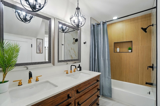 bathroom featuring double vanity, a sink, shower / tub combo with curtain, and a chandelier