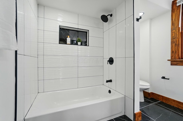 bathroom with toilet, baseboards, and shower / bath combination