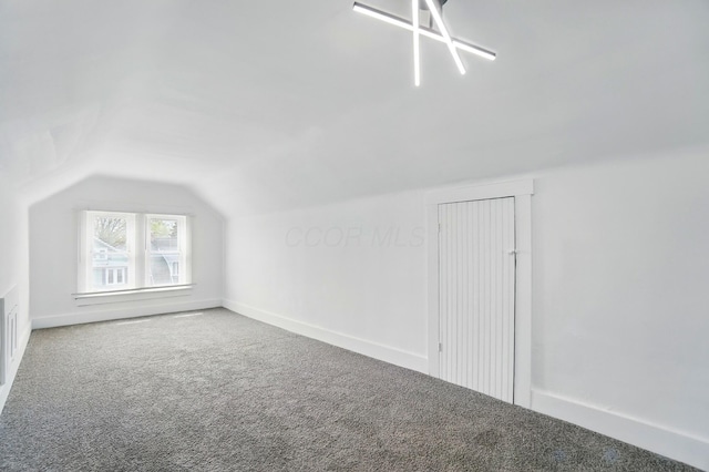 bonus room featuring baseboards, vaulted ceiling, and carpet