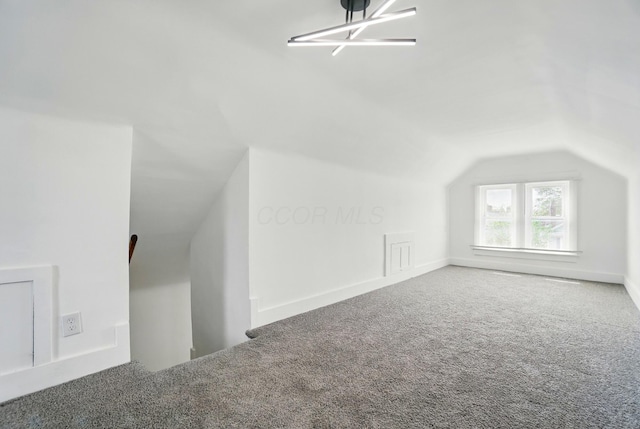 bonus room featuring carpet and vaulted ceiling