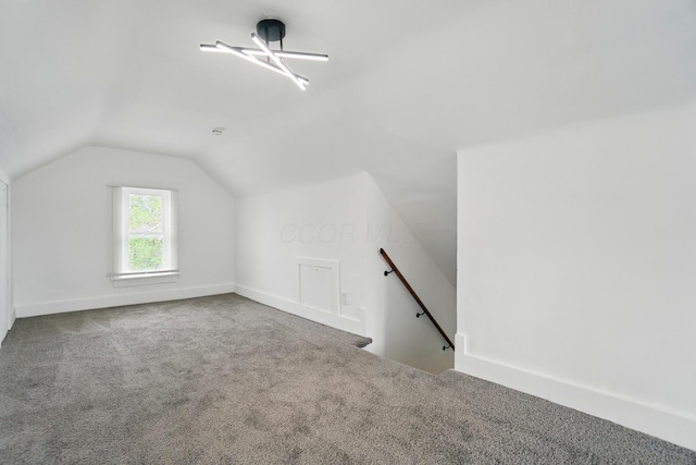 bonus room with carpet floors and lofted ceiling