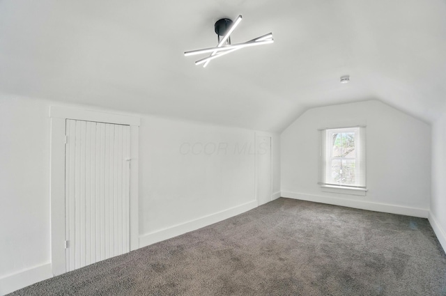 bonus room featuring baseboards, carpet, and lofted ceiling