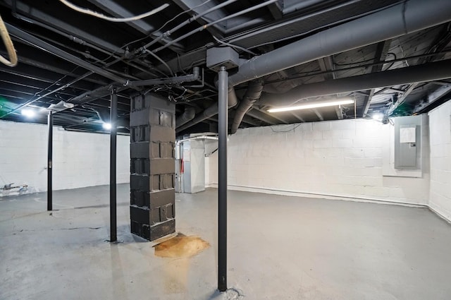 unfinished basement featuring heating unit and electric panel