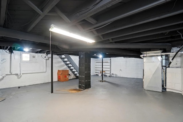 basement with heating unit and stairs