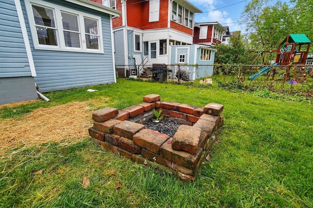 view of yard featuring a playground and fence