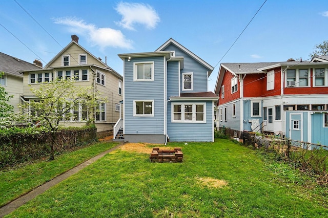 back of property with fence and a yard
