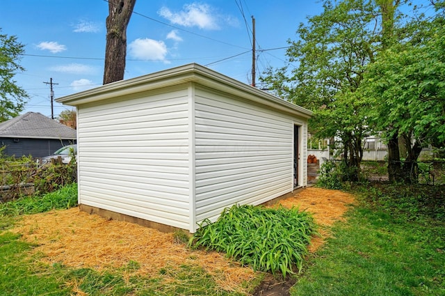 view of outbuilding with fence and an outbuilding